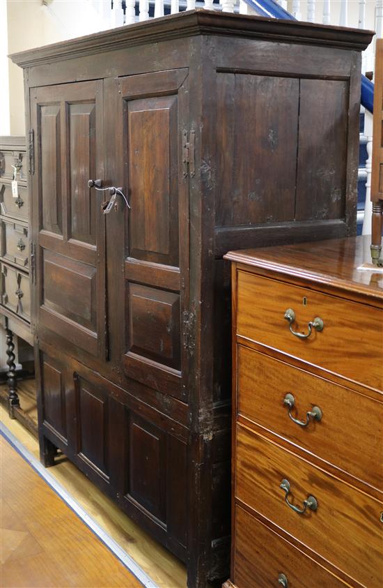 An early 18th century oak wardrobe / cupboard enclosed by fielded panels W.136cm